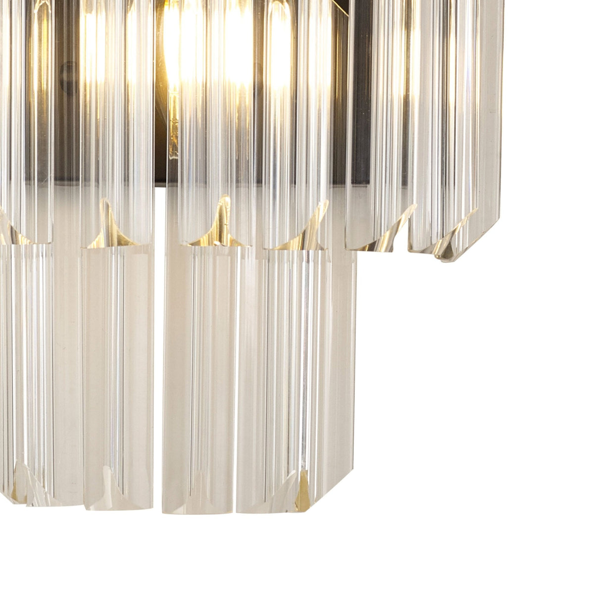 Close-up of the bottom section of the black and clear glass wall light with lights on.