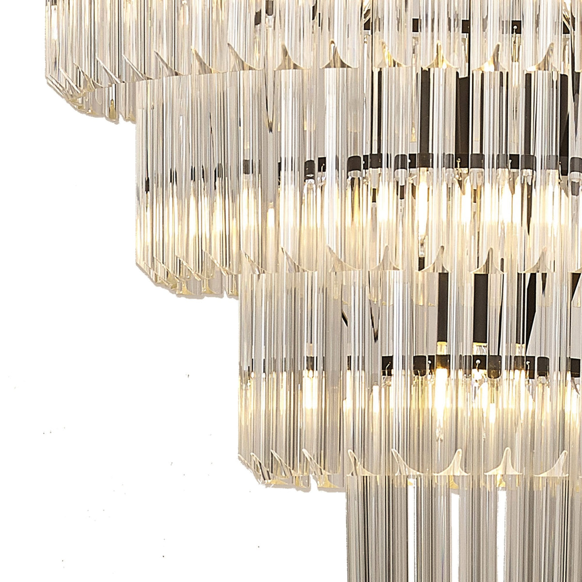 Close-up of the illuminated clear fluted glass rods on the tiered chandelier.