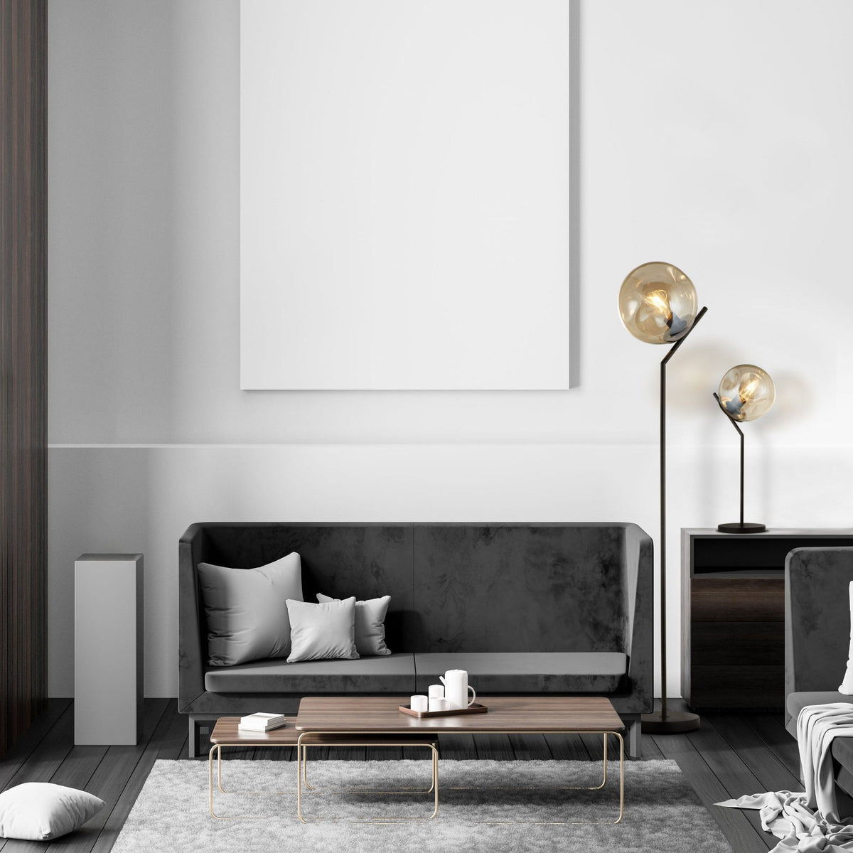 A modern living room featuring a dark sofa, coffee table, and matching floor and table lamps.