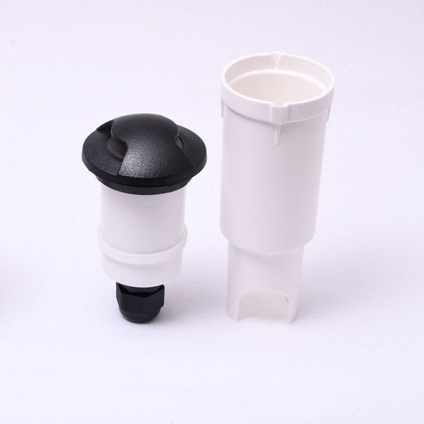 Two boat drain plugs, one assembled in black and white, and one in white.