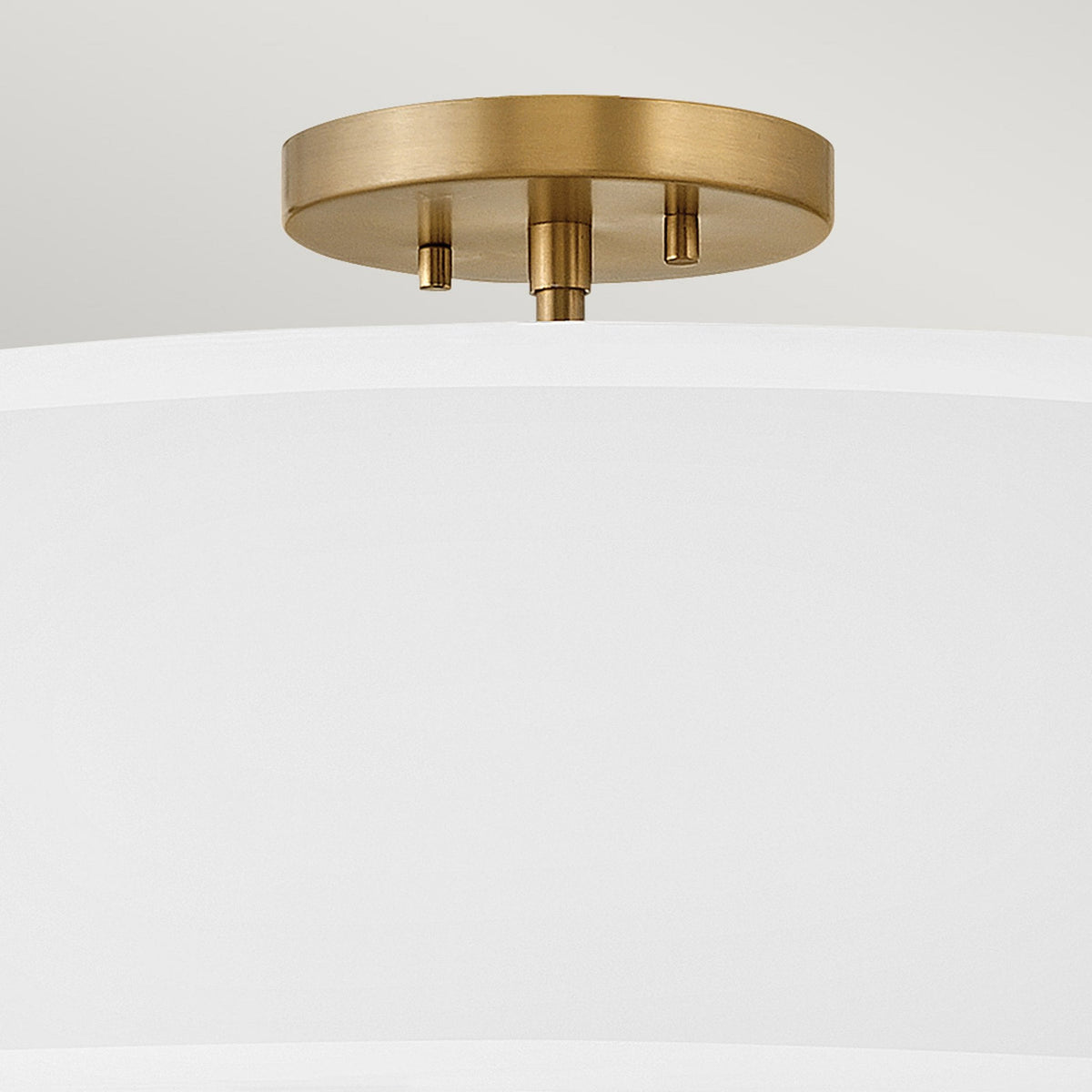 A close-up of the brass ceiling rose and fittings of the semi-flush ceiling light.