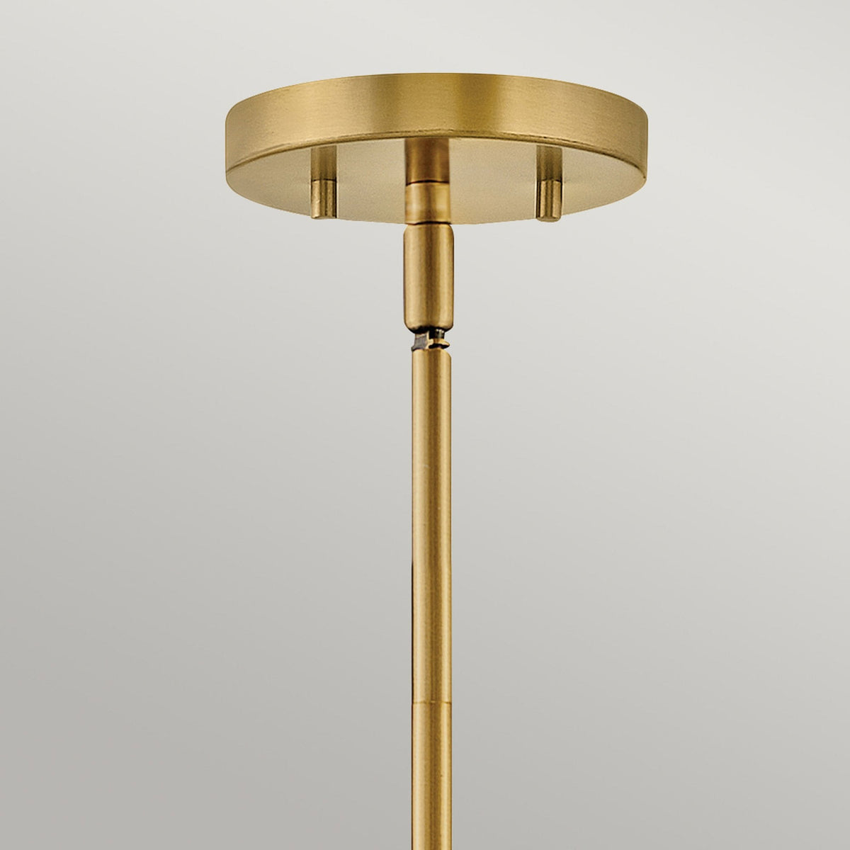 A close-up of the brass rod and ceiling rose for the pendant light fixture.