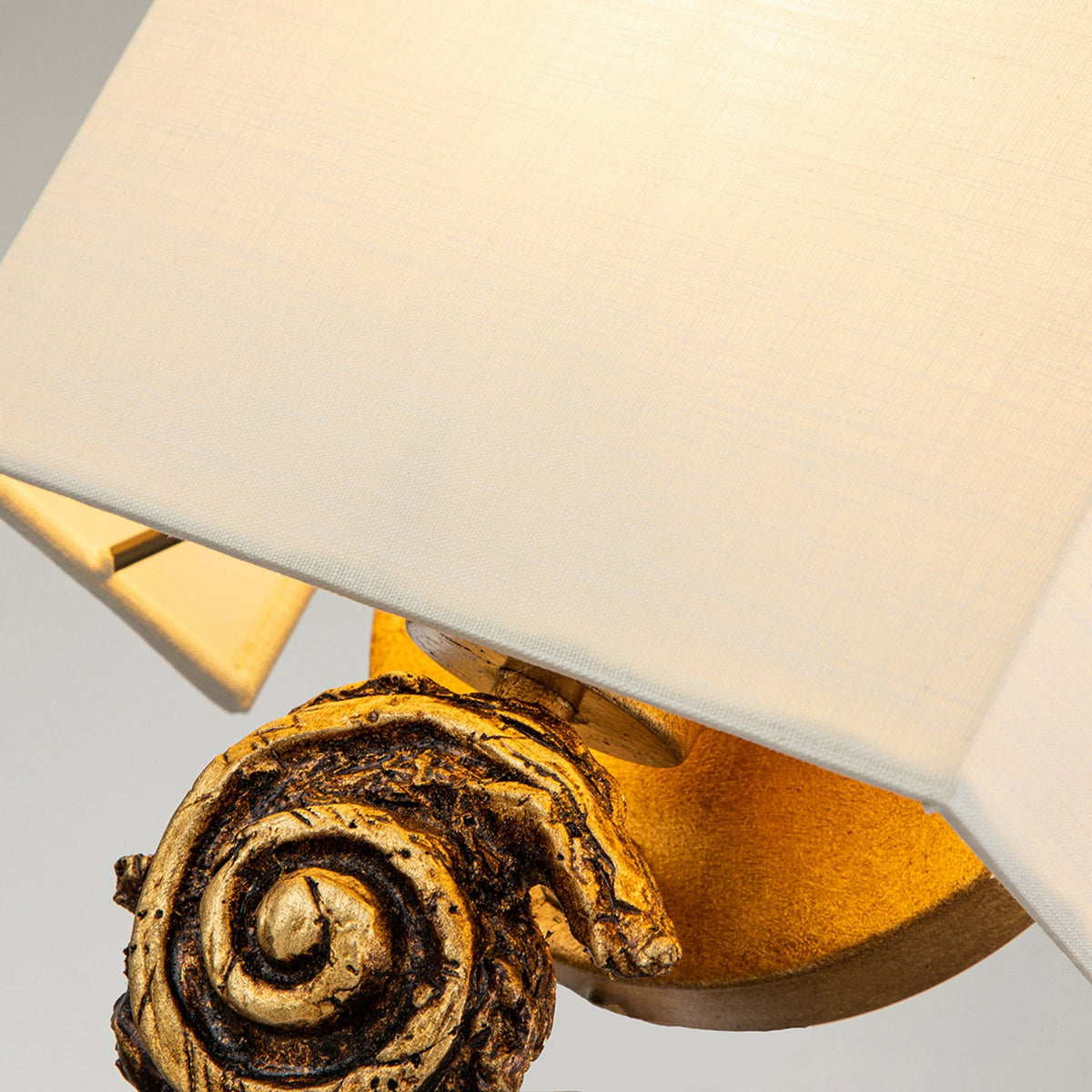 Swirl Small Wall Light in an Antiqued Gold Leaf Finish with Linen Shade