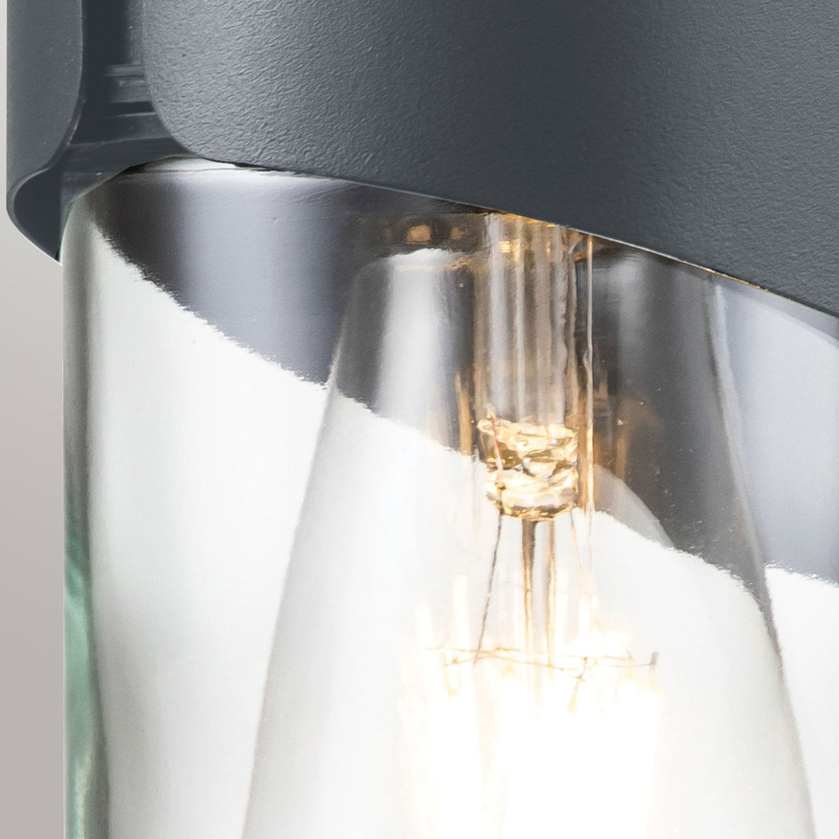 A close up of the E27 LED filament bulb inside the modern curved grey wall light.
