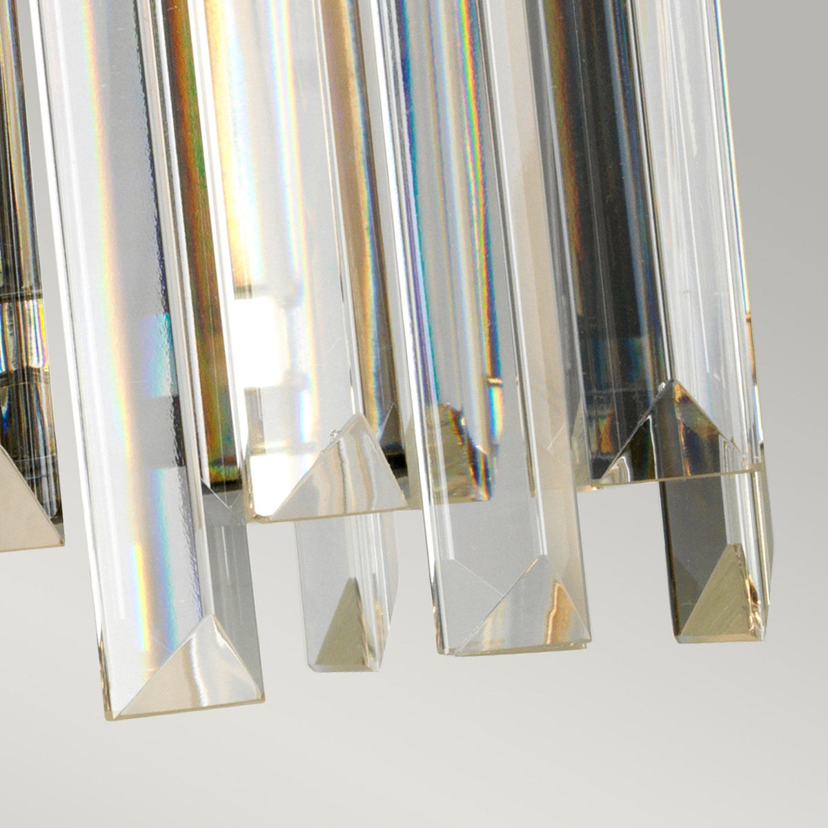 A detailed close-up of the rectangular crystal drops on a wall light, showcasing their clarity.