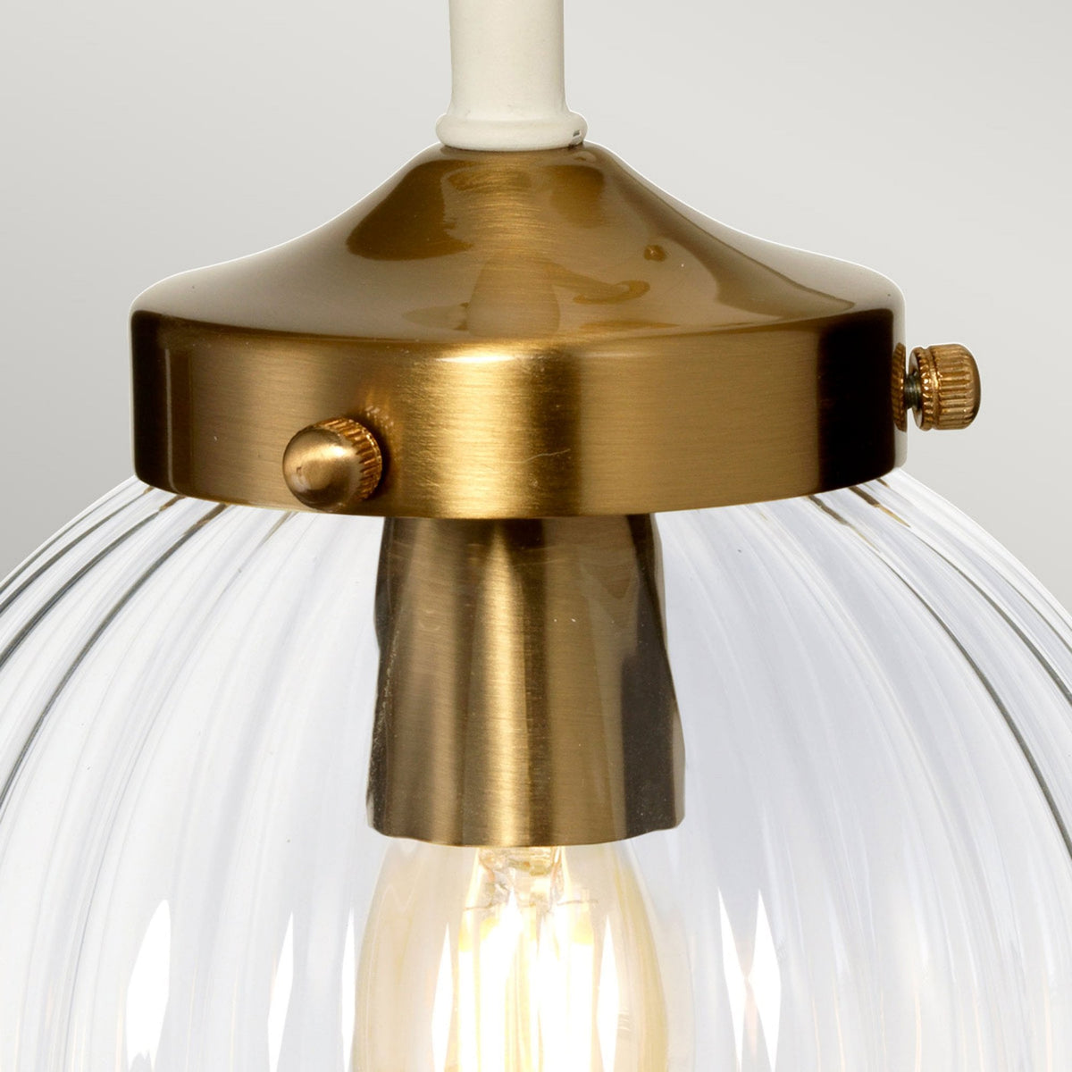 Cosmos Wall Light in a Cream Finish with Aged Brass Detailing and Clear Ribbed Glass