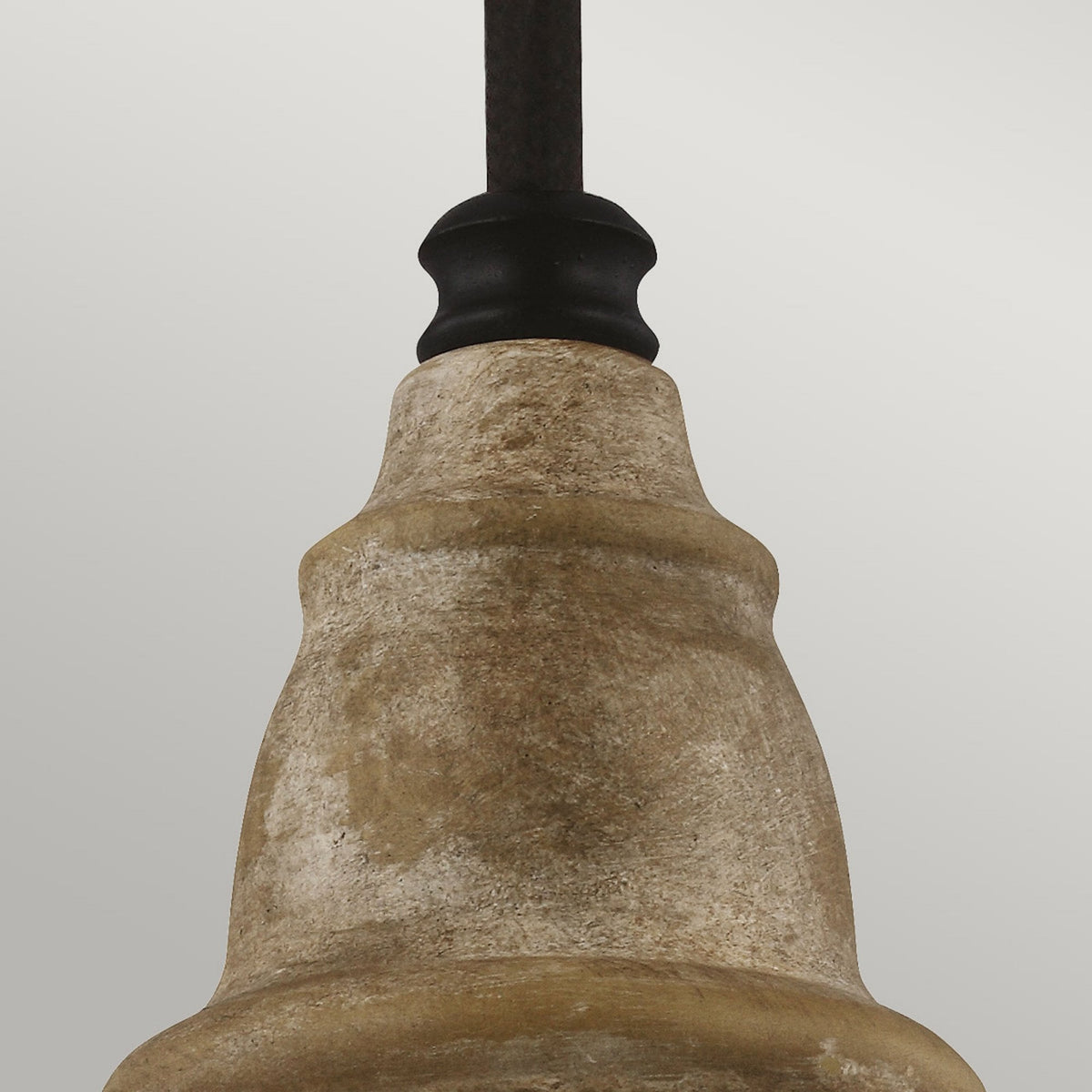 Close-up of the textured, aged metal accent on a pendant light.