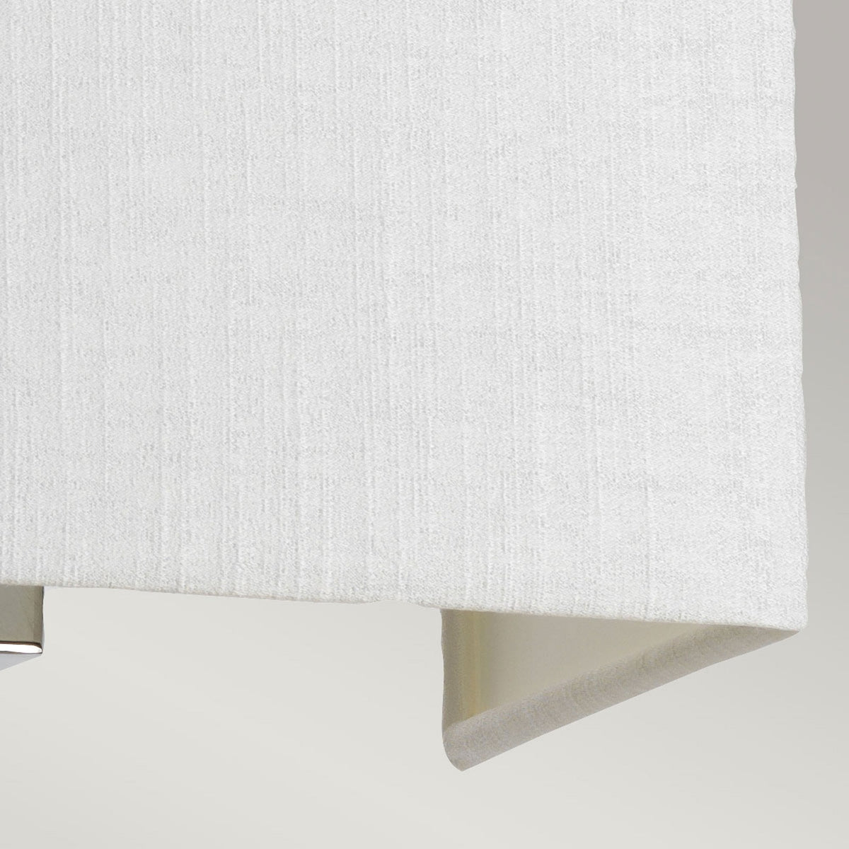 Close-up of the bottom edge and fabric texture of a white rectangular wall light.