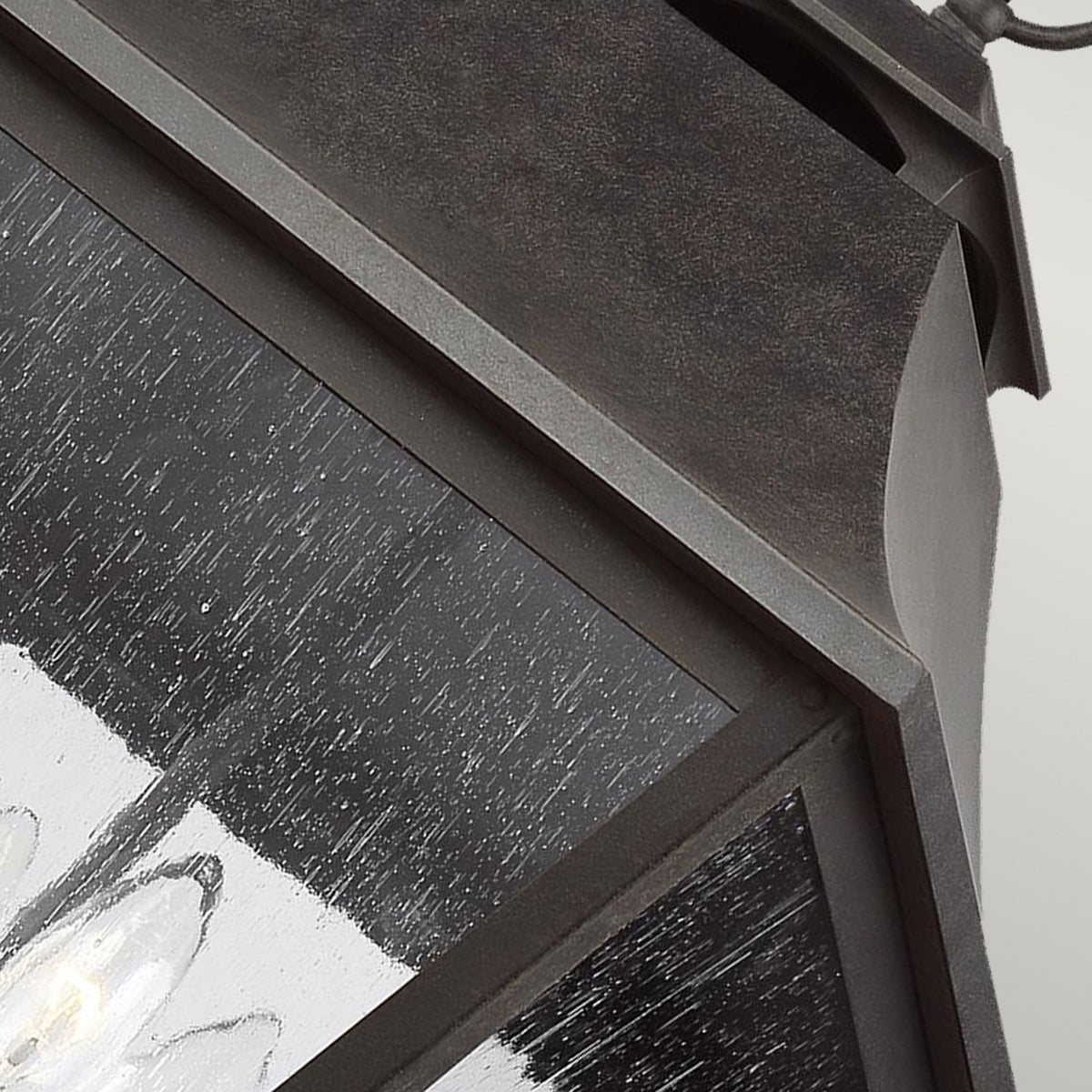 Close-up of the dark finish and textured seeded glass on the outdoor hanging lantern.