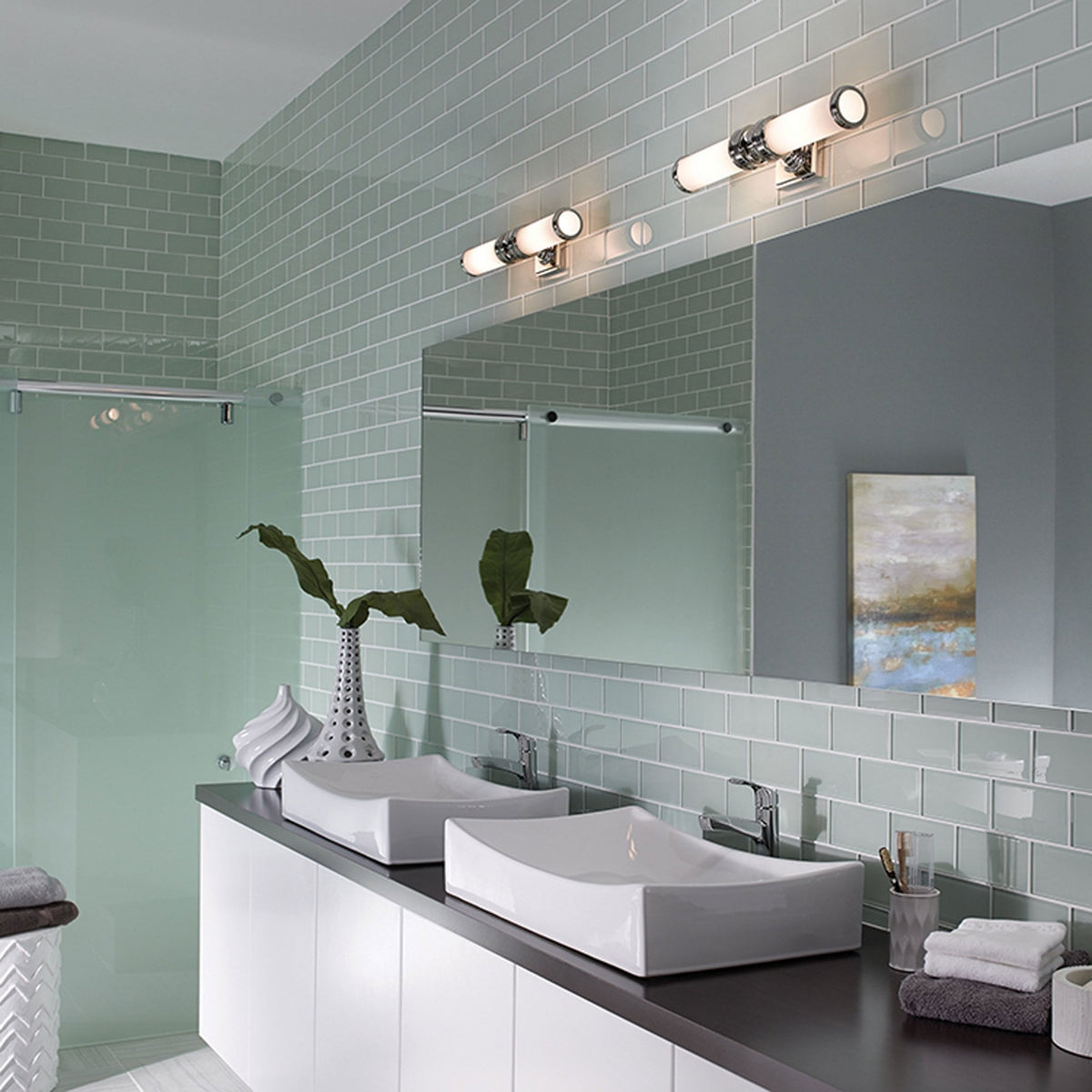 A modern bathroom with two twin tube wall lights above a double basin vanity.