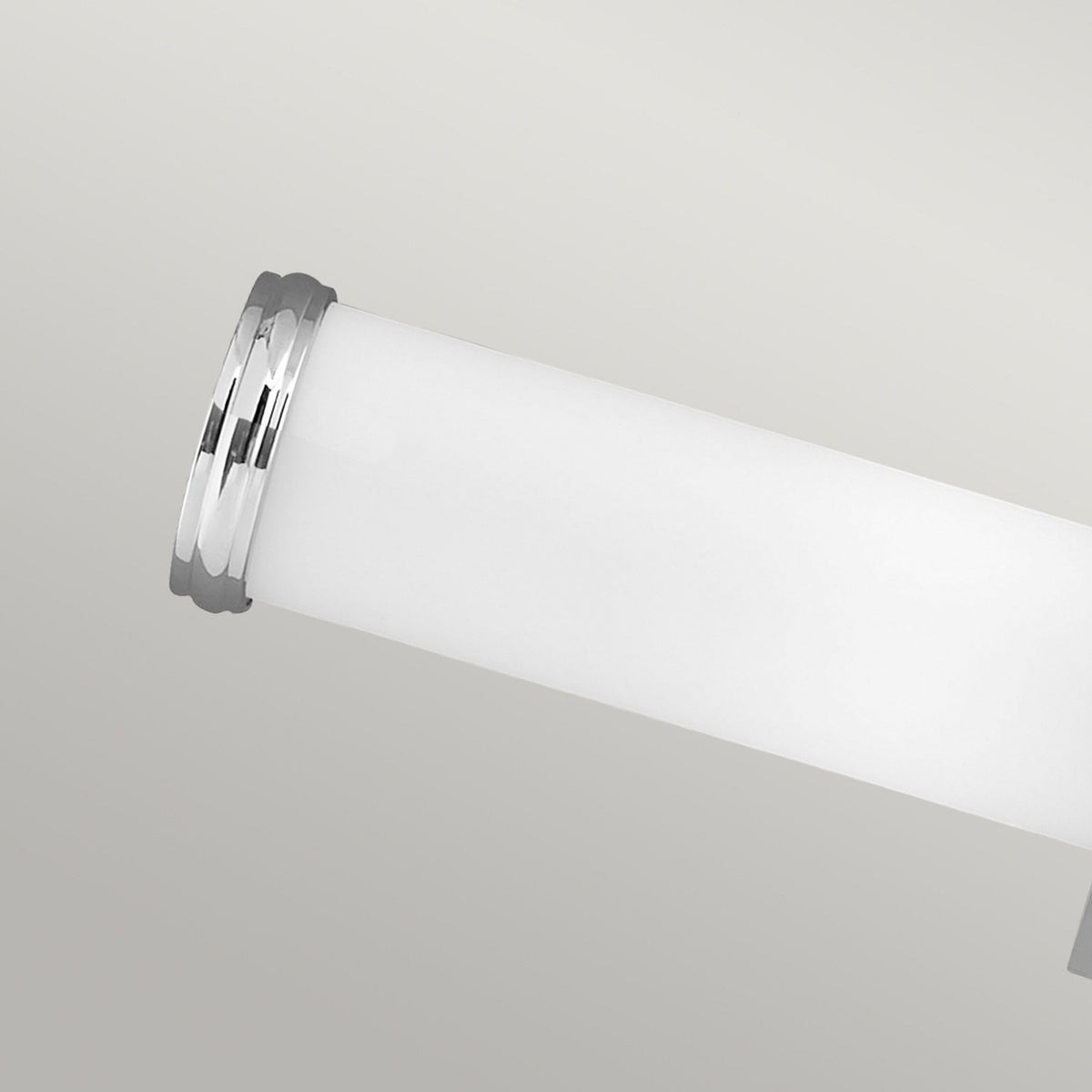 A detailed view of the end of a white opal glass tube with chrome banding.