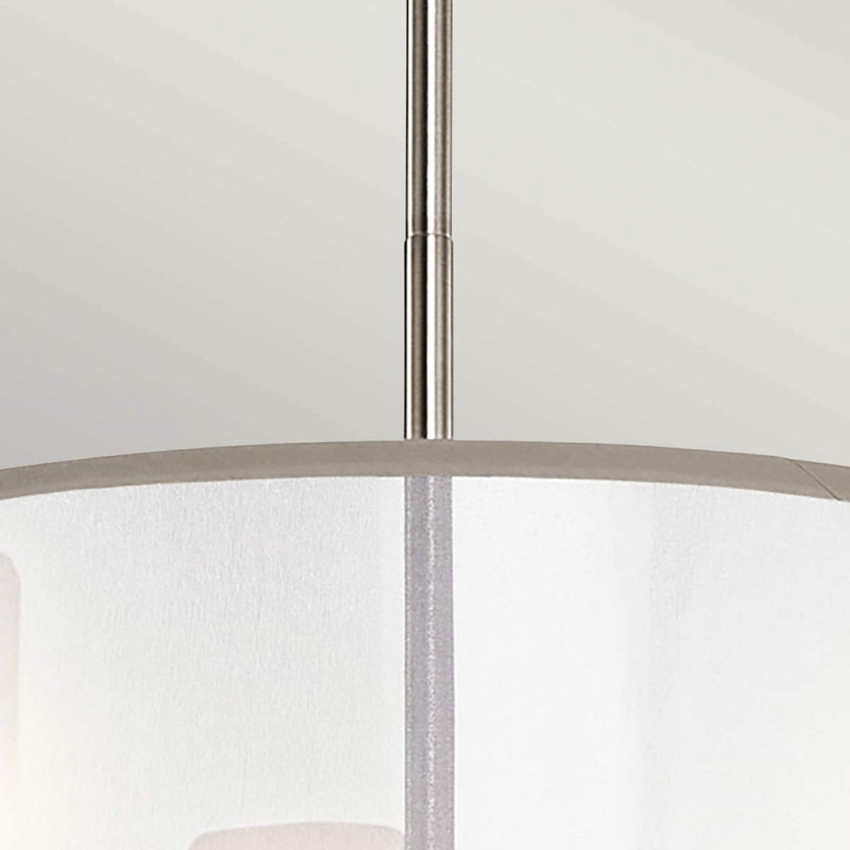 Close-up of the brushed nickel rod connecting the light fixture to the ceiling mount.