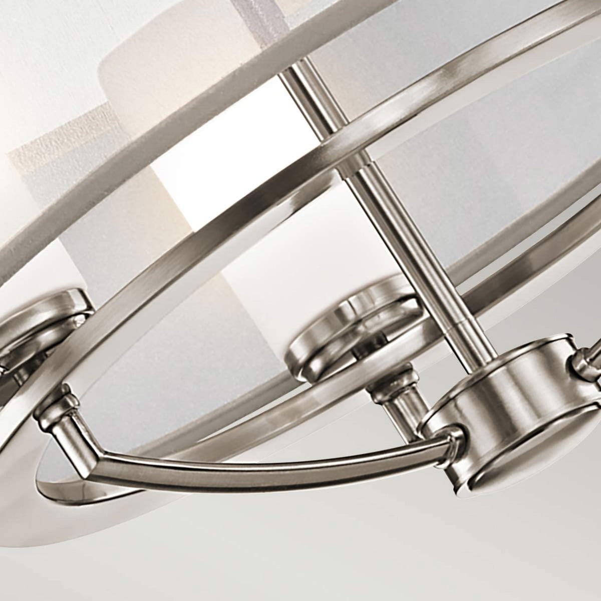 Close-up of the metal framework and lightbulb sockets within the ceiling light's design.
