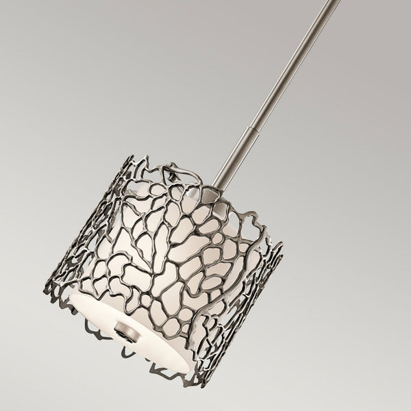 A close-up, angled view of the decorative metal shade with an organic, branching pattern.