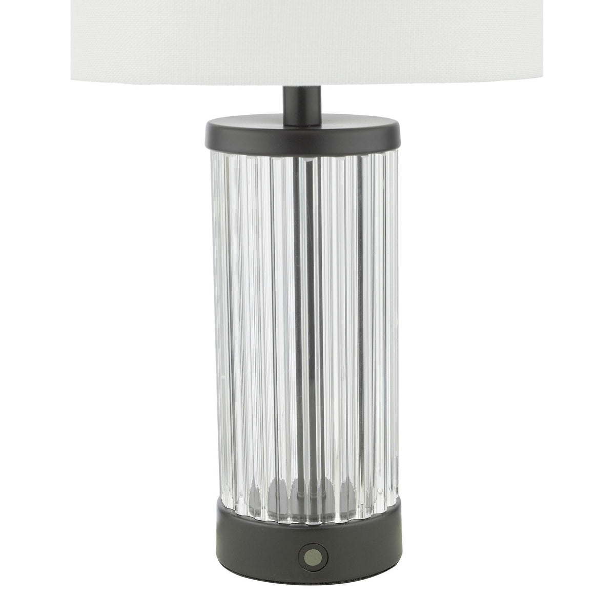 Modern table lamp with a white fabric shade, a black base, and a clear fluted glass body.