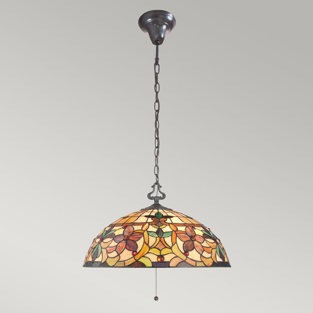 Full view of a dome-shaped stained-glass ceiling light with a floral pattern, featuring a chain.
