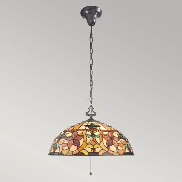 Full view of a dome-shaped stained-glass ceiling light with a floral pattern, featuring a chain.