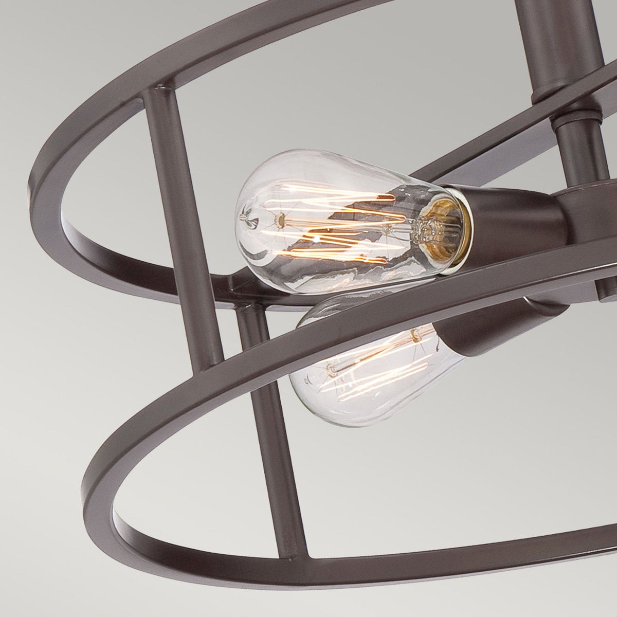 Close-up of the exposed bulb and bronze finish of a semi-flush convertible light.