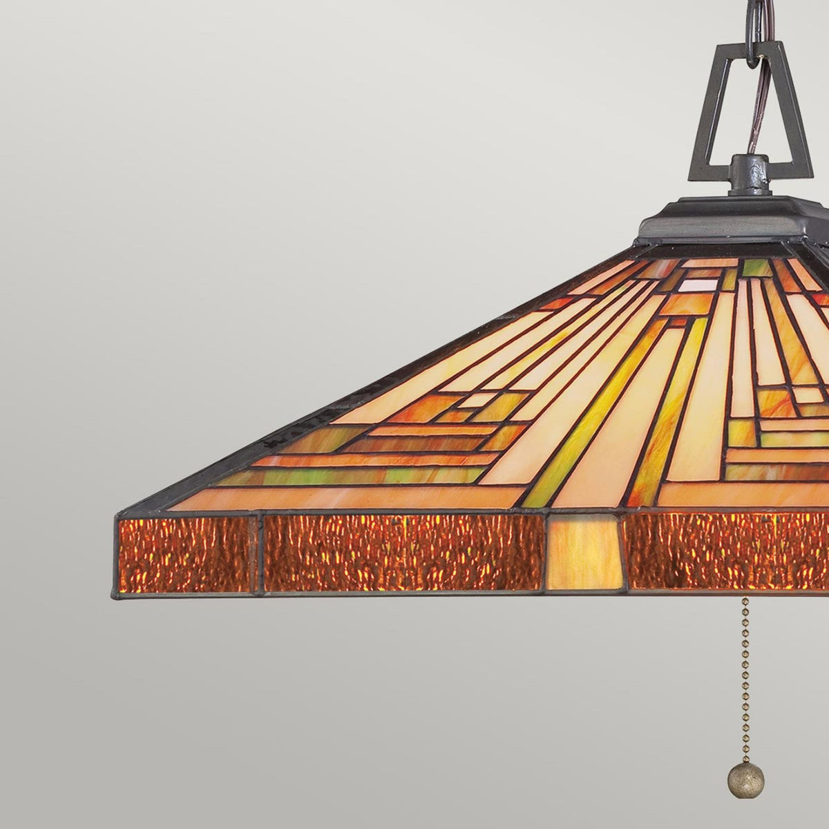 Close-up of the side of a square Tiffany glass pendant light with a pull chain.