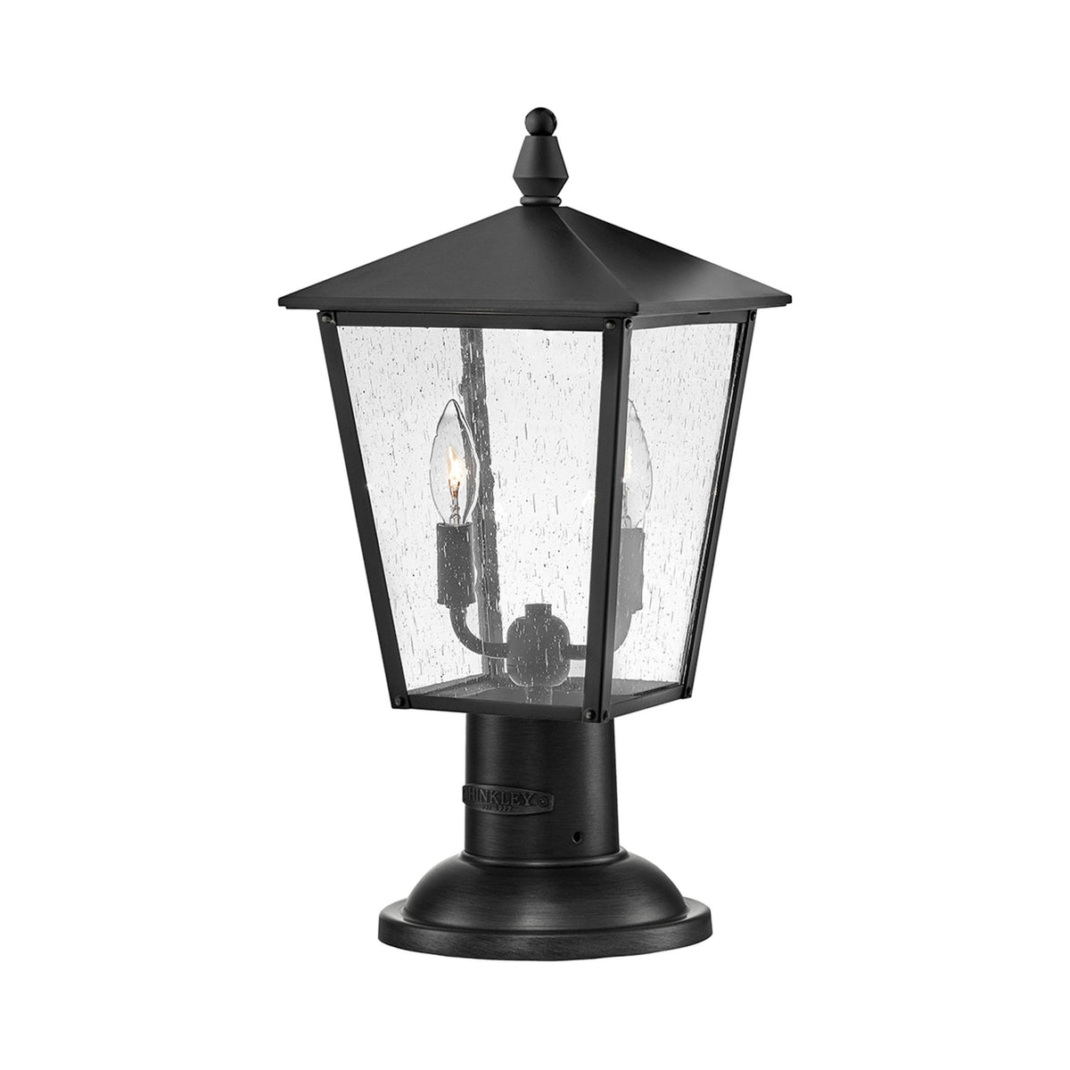 A sleek black outdoor post light featuring two exposed bulbs behind clear seeded glass panels.