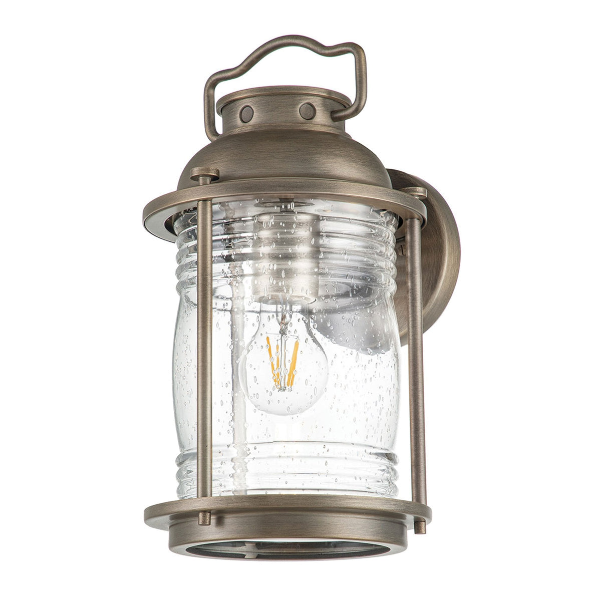 A bronze outdoor lantern with a clear, seeded glass shade and an exposed bulb.