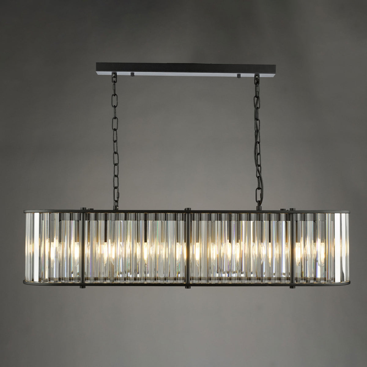 Rectangular chandelier with clear glass rods and a dark metal frame, suspended by chains.