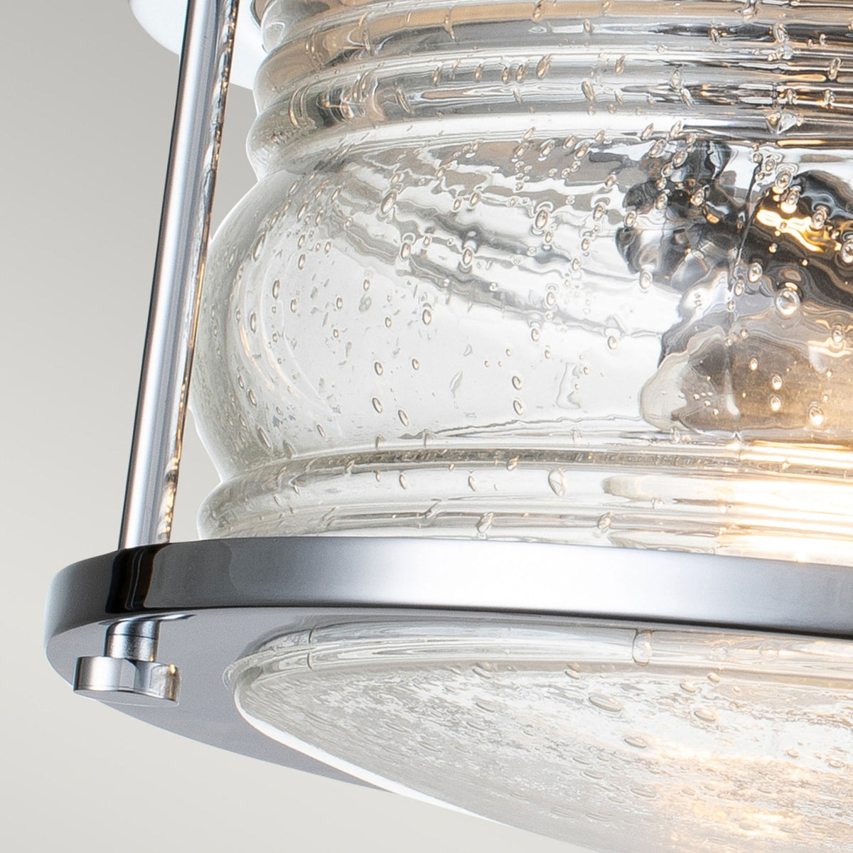A detailed shot of the seeded glass texture and chrome accents of the light.