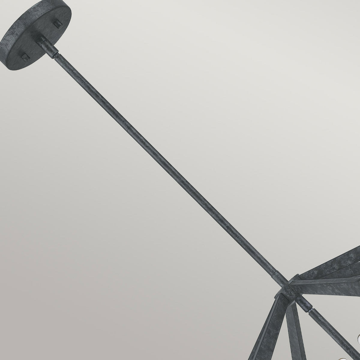 Detail of the ceiling canopy and hanging rod of the dark geometric pendant light.