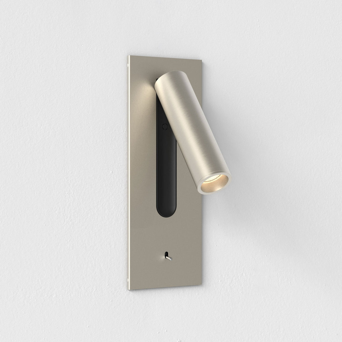 Brushed nickel wall-mounted light fixture with a cylindrical spotlight and a small toggle switch