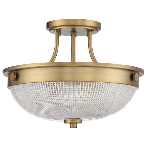 A close-up of a semi-flush ceiling light with an antique brass finish and a clear seeded glass bowl.