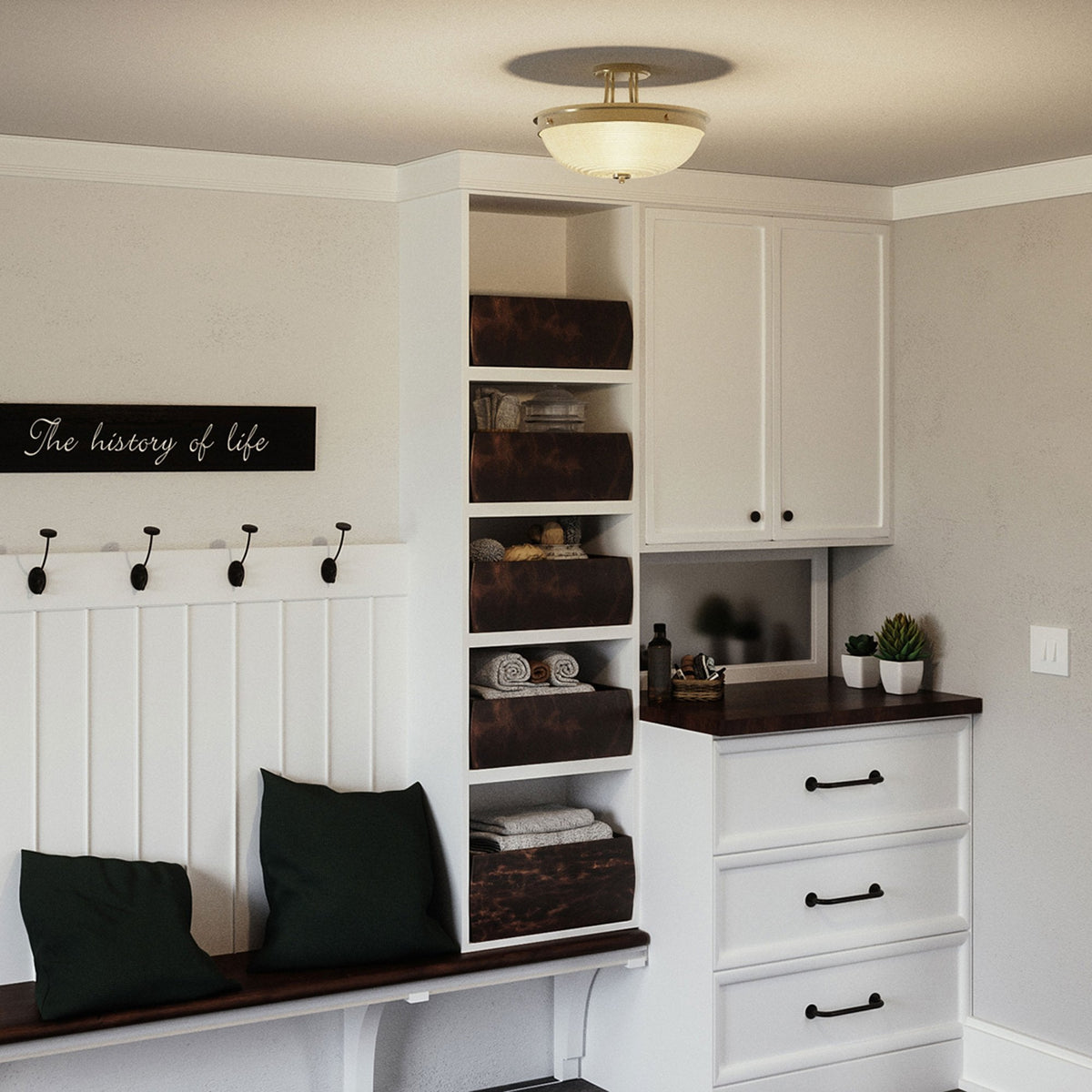 A semi-flush ceiling light with an antique brass finish illuminates a laundry room.