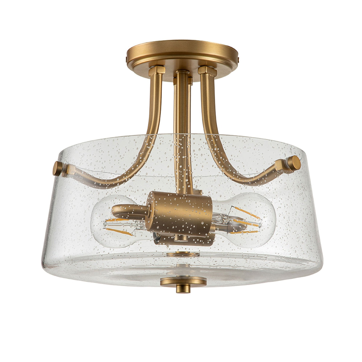 A modern brass semi-flush mount ceiling light with a seeded glass shade and two bulbs.