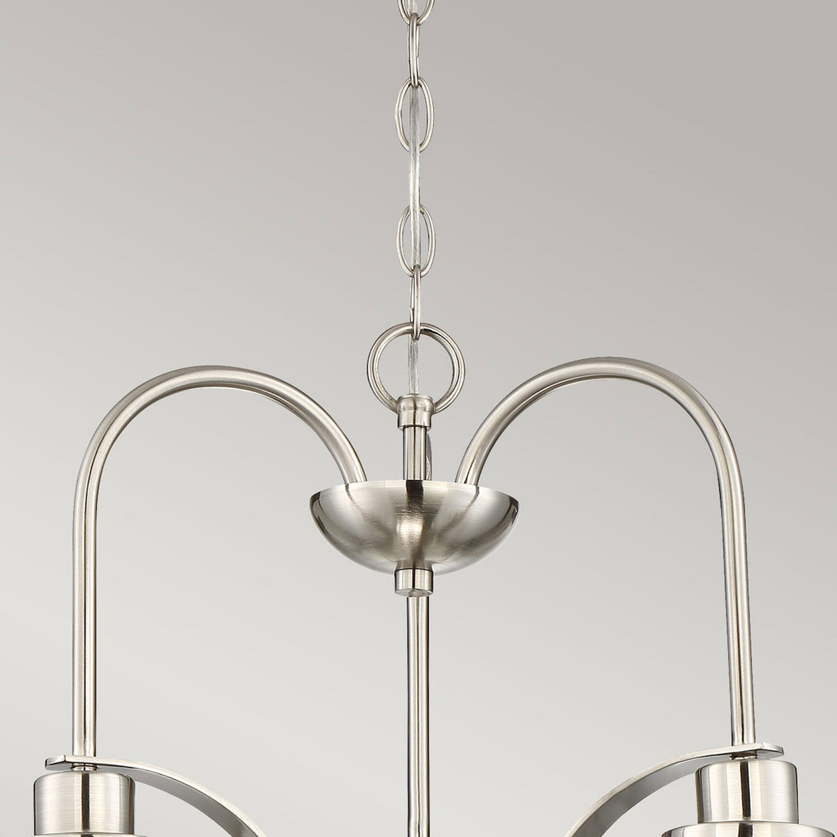 Top portion of the brushed nickel chandelier, highlighting the chain and ceiling rose.