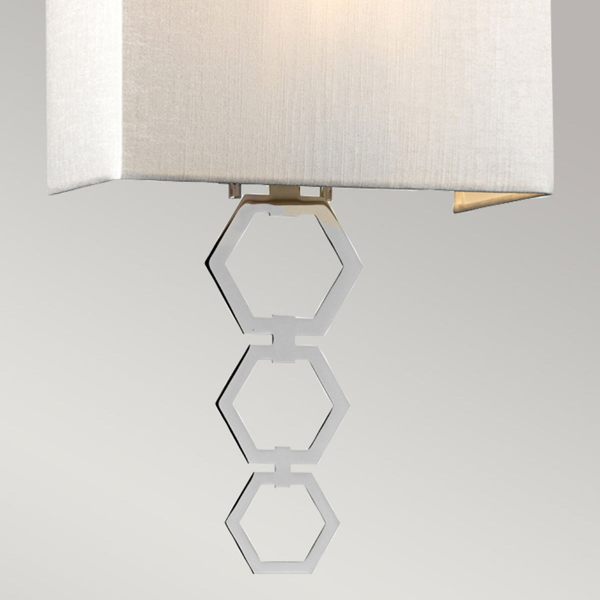 Close-up of the chrome hexagonal link detailing beneath the light shade.