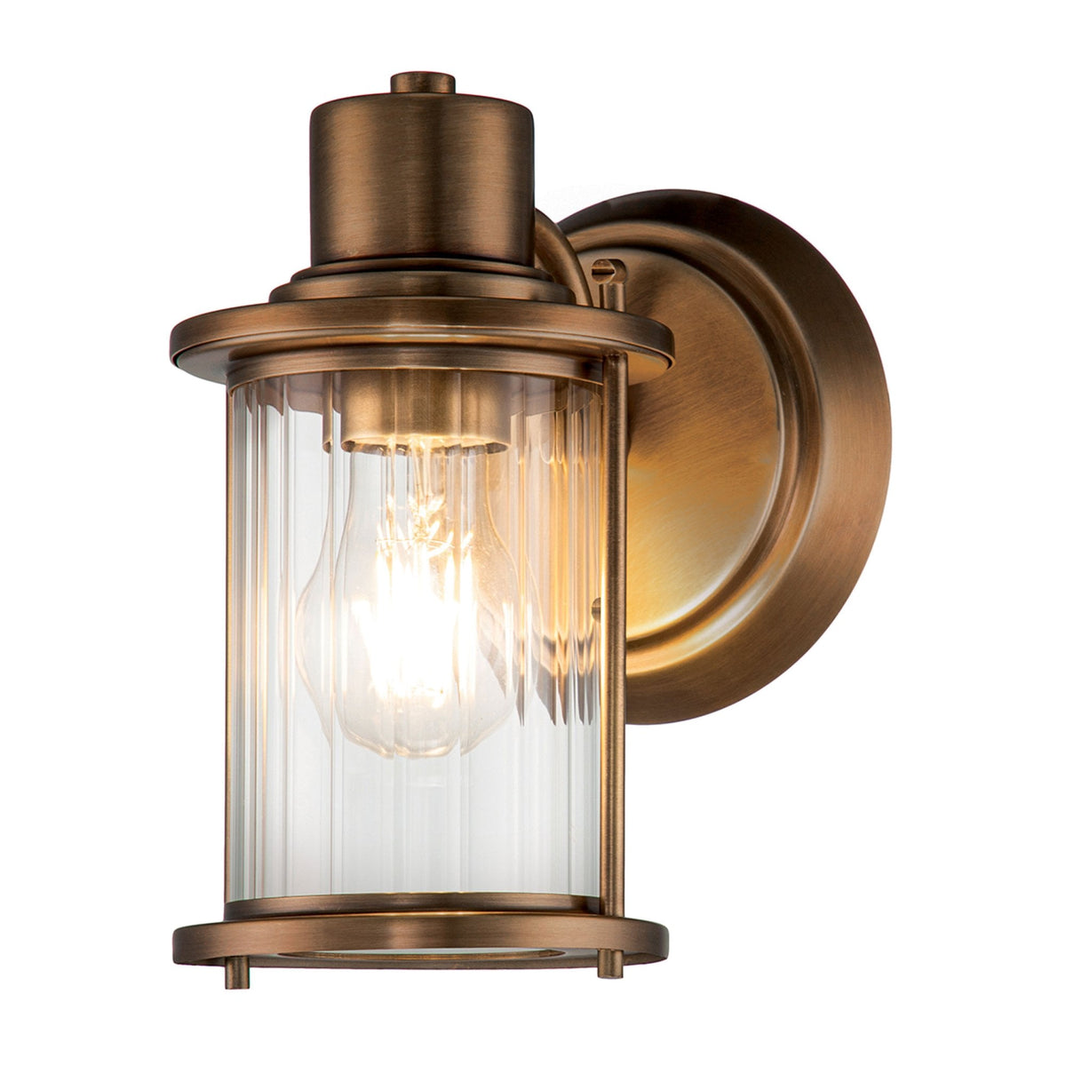 A close-up view of the bronze nautical wall light, illuminated with a warm glow. 