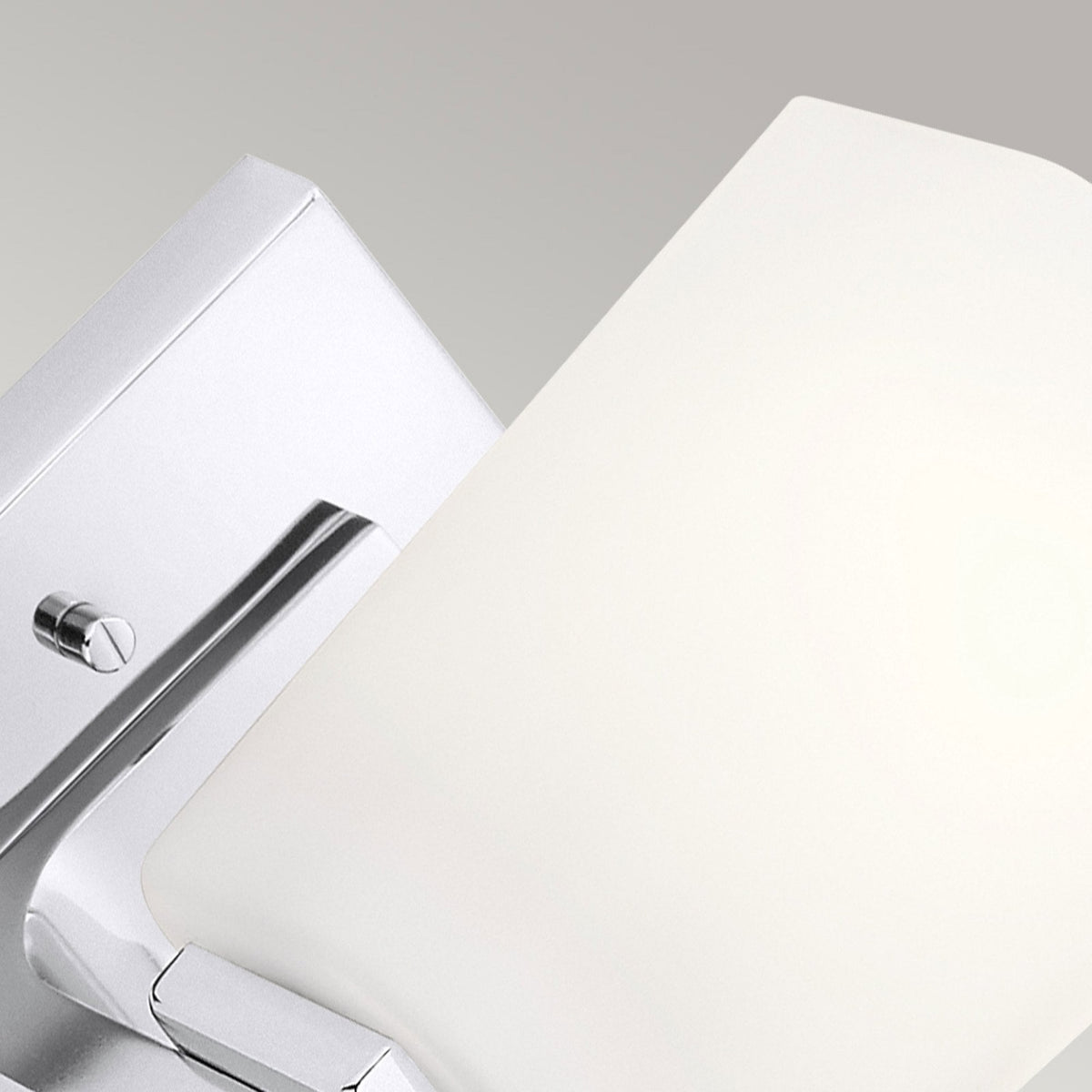 Close-up of the square wall plate and frosted glass shade of a modern light.