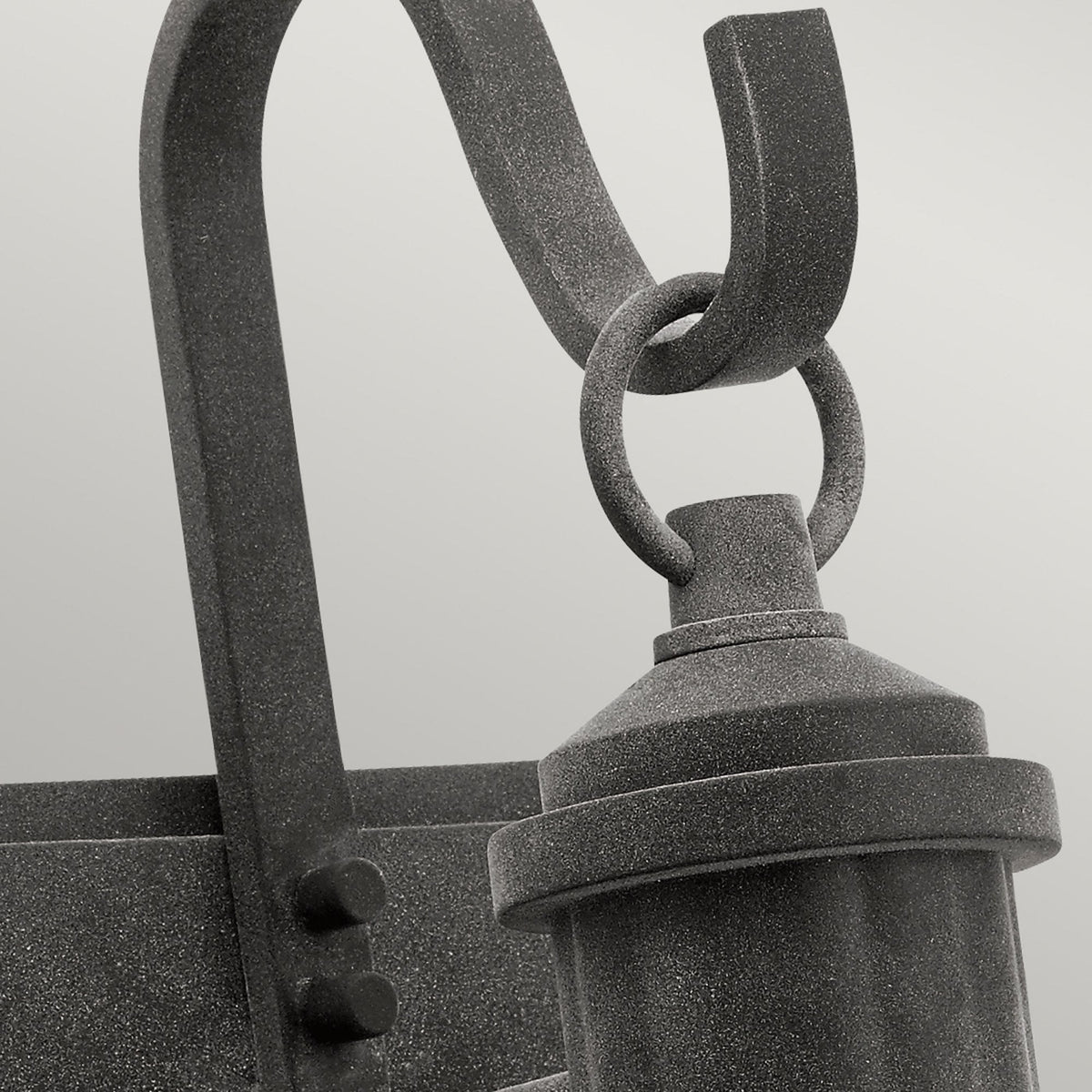 A detailed close-up of the top portion of the black outdoor wall light, highlighting its texture.