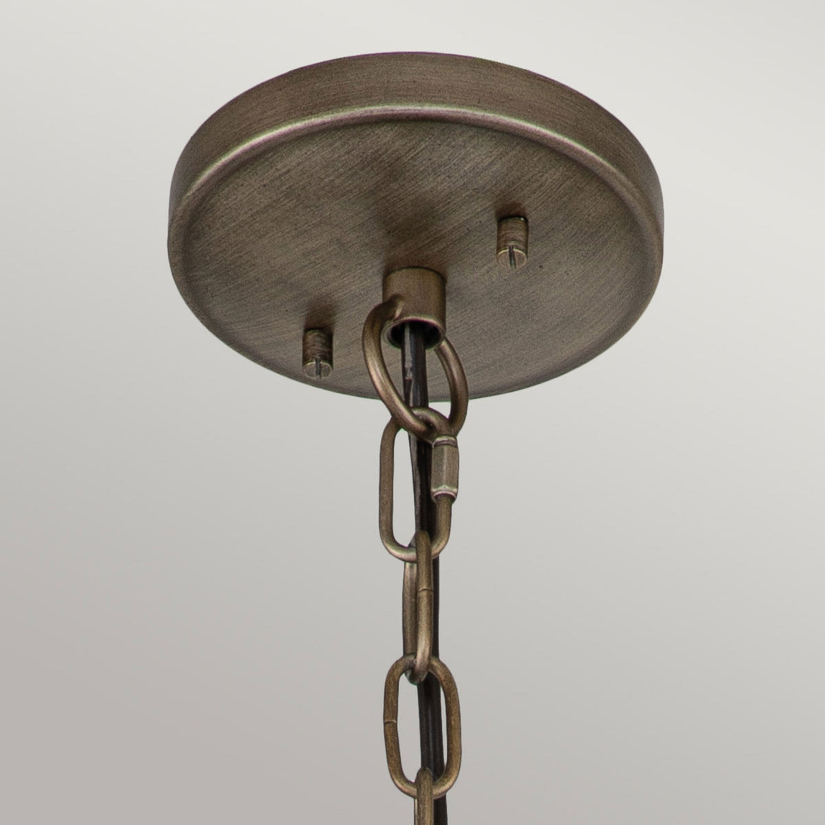 Close-up of the ceiling rose and chain of the bronze globe outdoor pendant light.