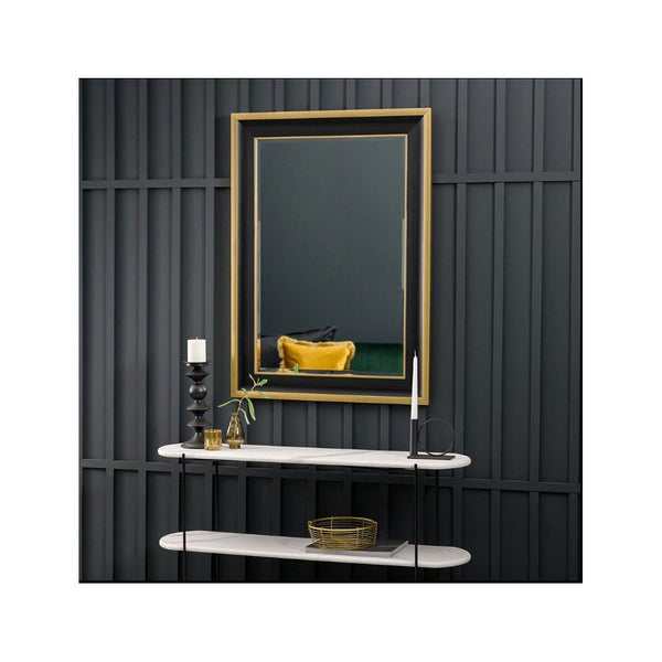 A rectangular mirror with a gold and dark frame hangs above two white shelves.
