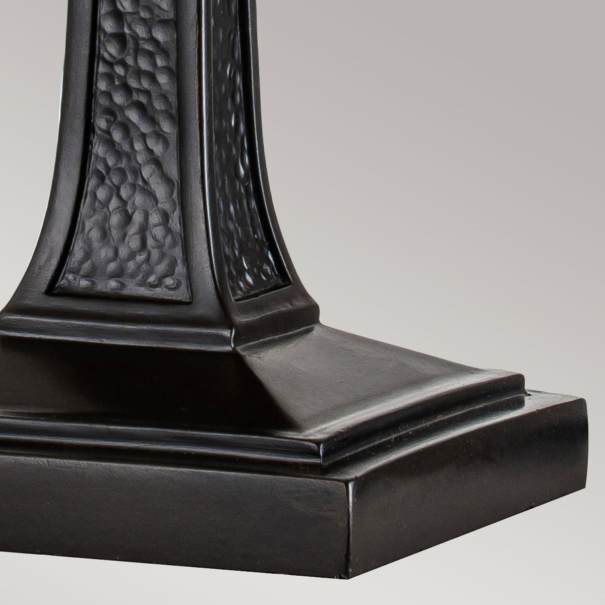 Close-up of the lamp's sturdy black base and lower part of the textured stand.