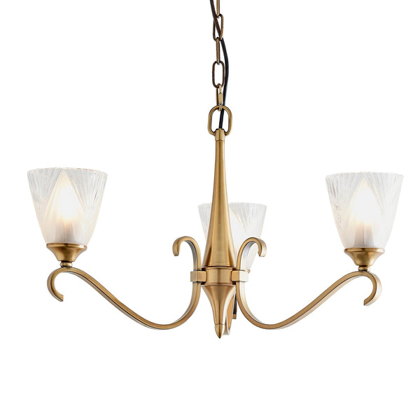 Close-up of a three-light brass chandelier with frosted, fluted glass shades.