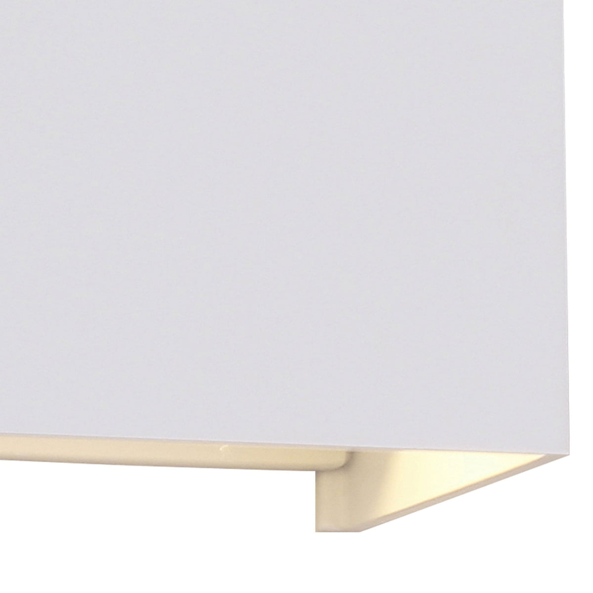 A close-up view of the bottom edge of a white square wall light, showing the light output.