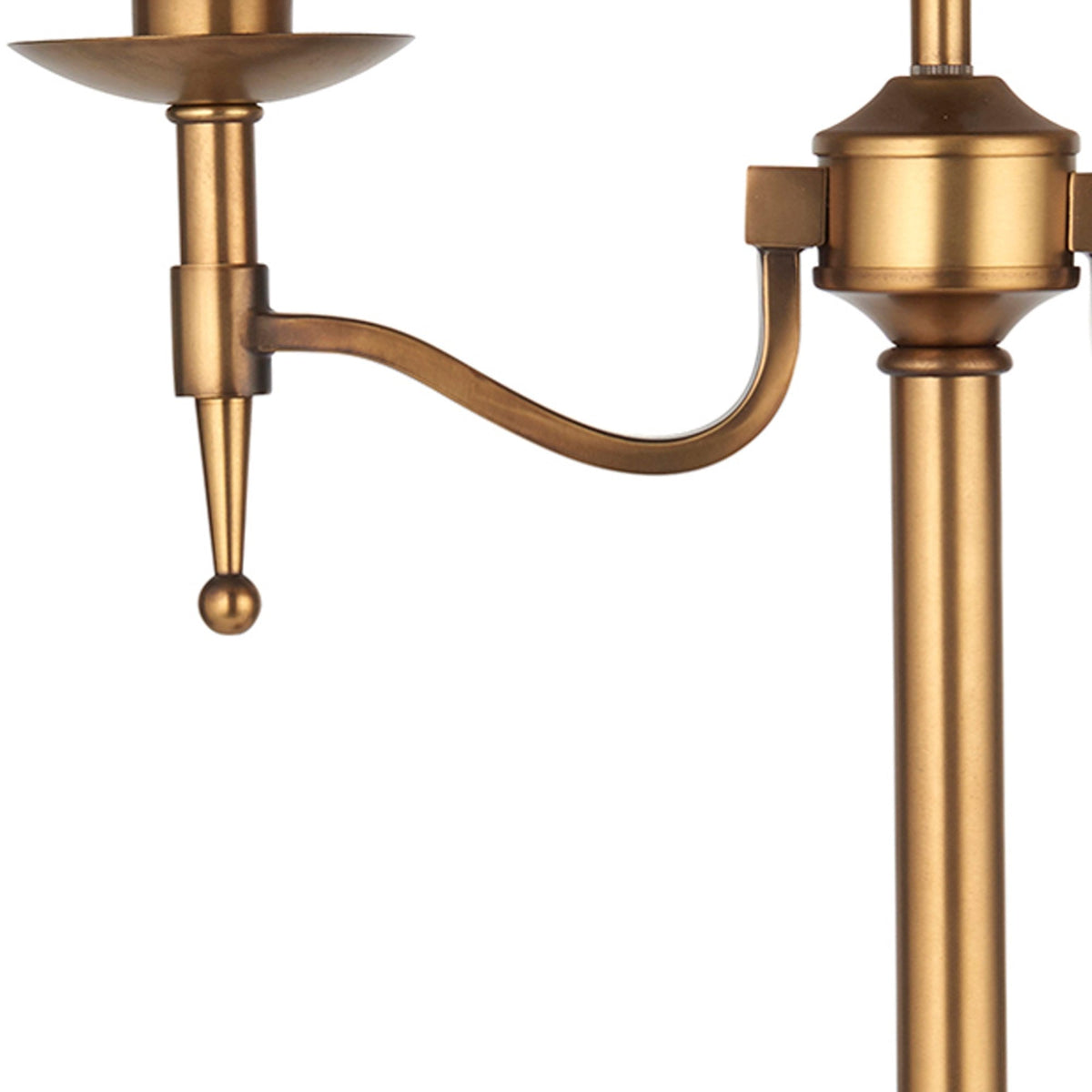 Close-up of the elegant brass arm and detailing on a classic table lamp.