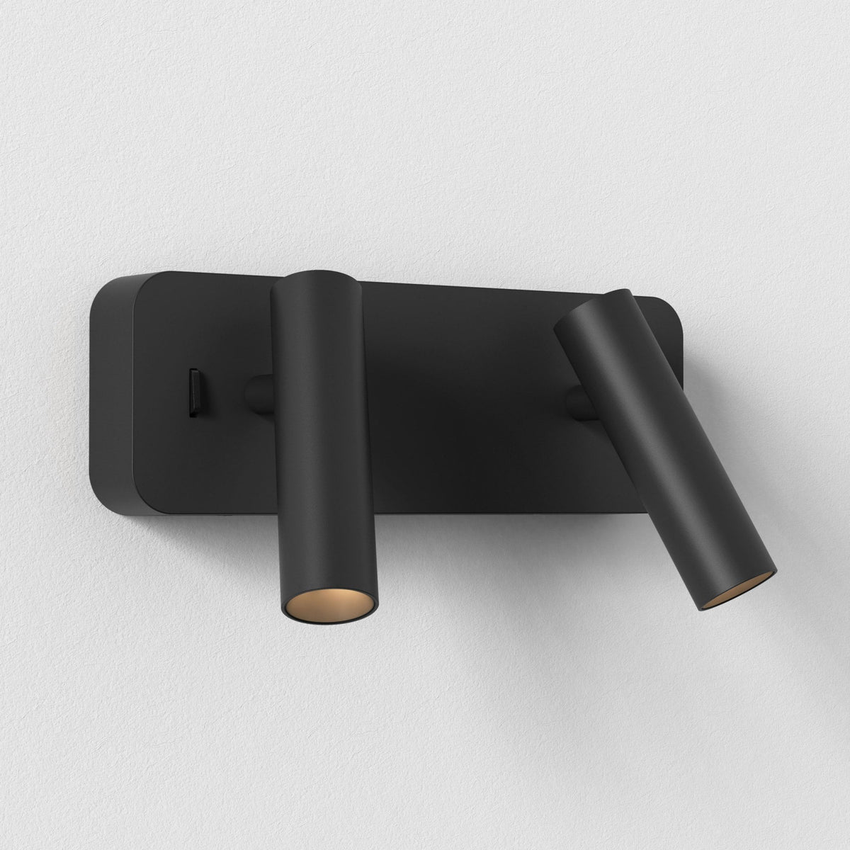 Black wall light with two adjustable cylindrical spotlights, one pointing down, one angled right