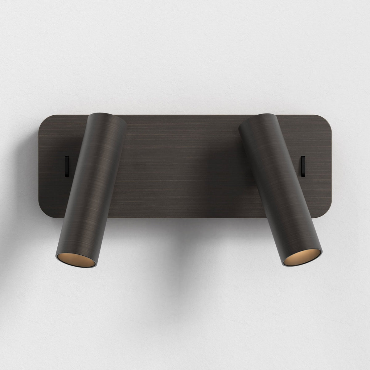 Two dark bronze cylindrical wall lights on a rectangular base