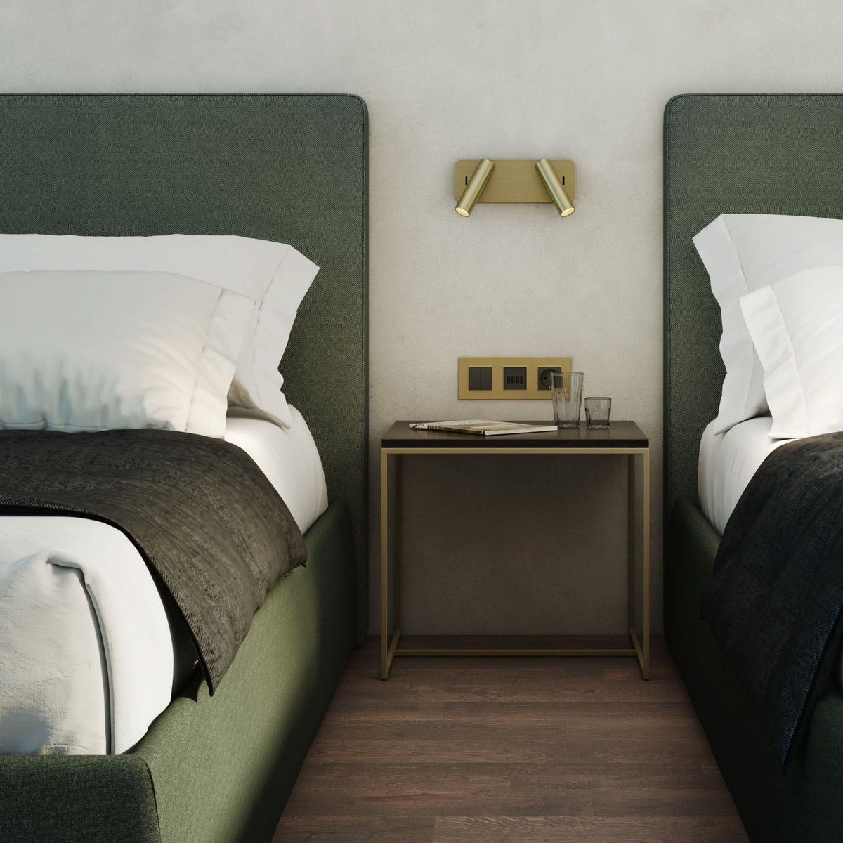 Two beds with green headboards and white bedding, a dark throw, and a nightstand with glasses and a magazine