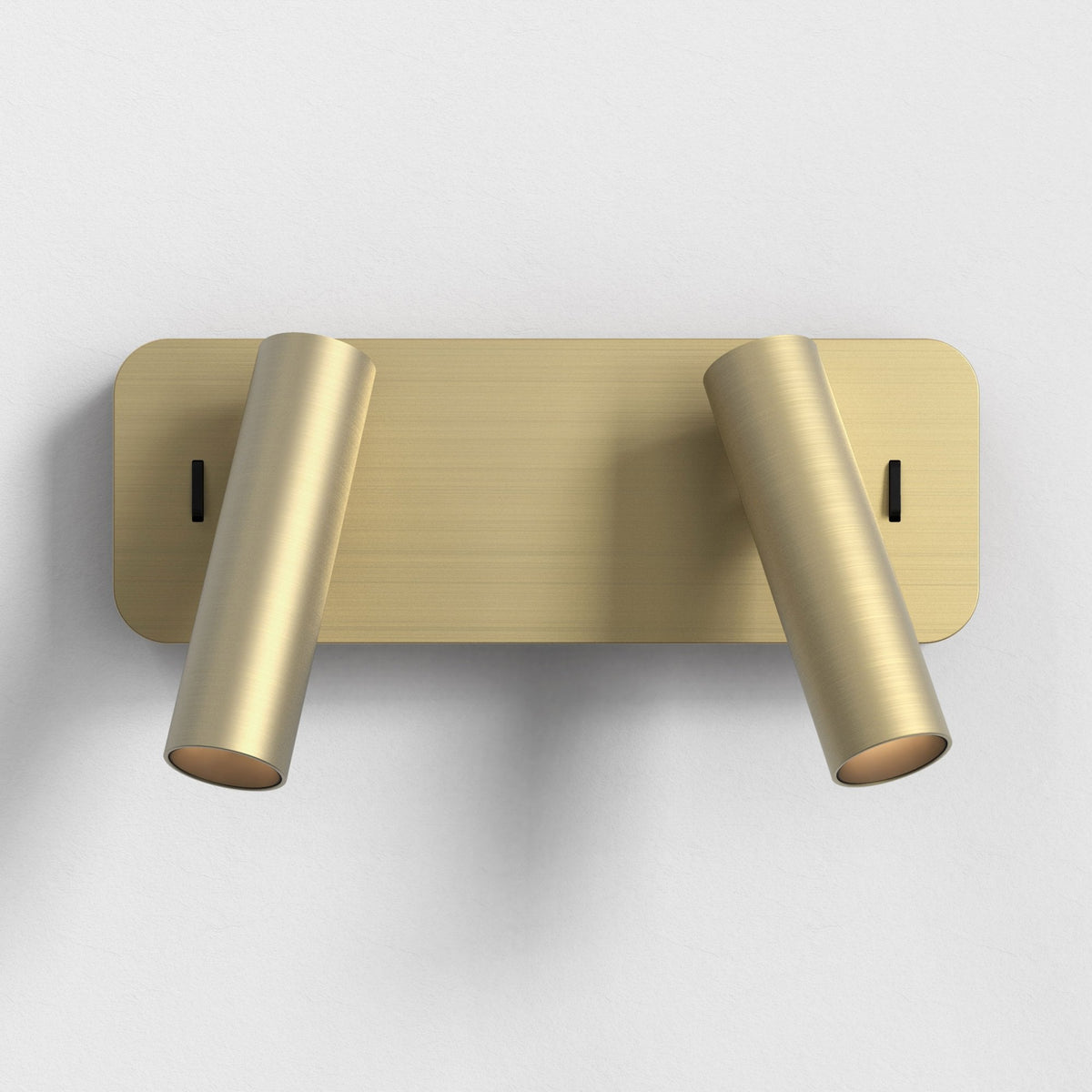 Two gold cylindrical wall lights on a gold rectangular base with rounded corners