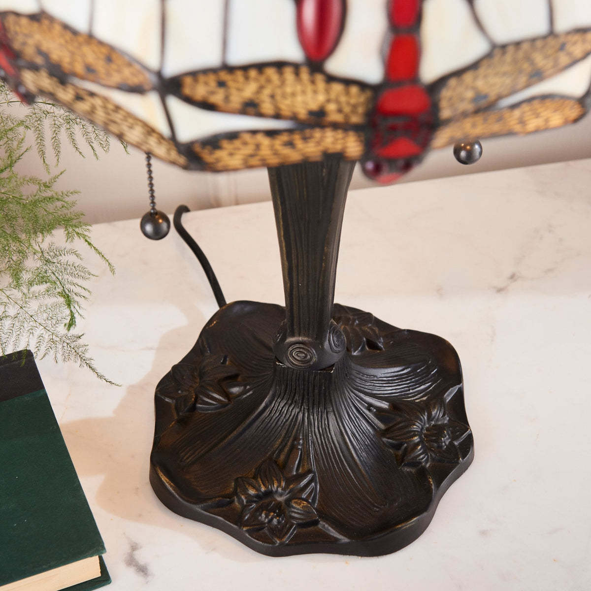 Close-up view of the decorative base of the Tiffany table lamp.