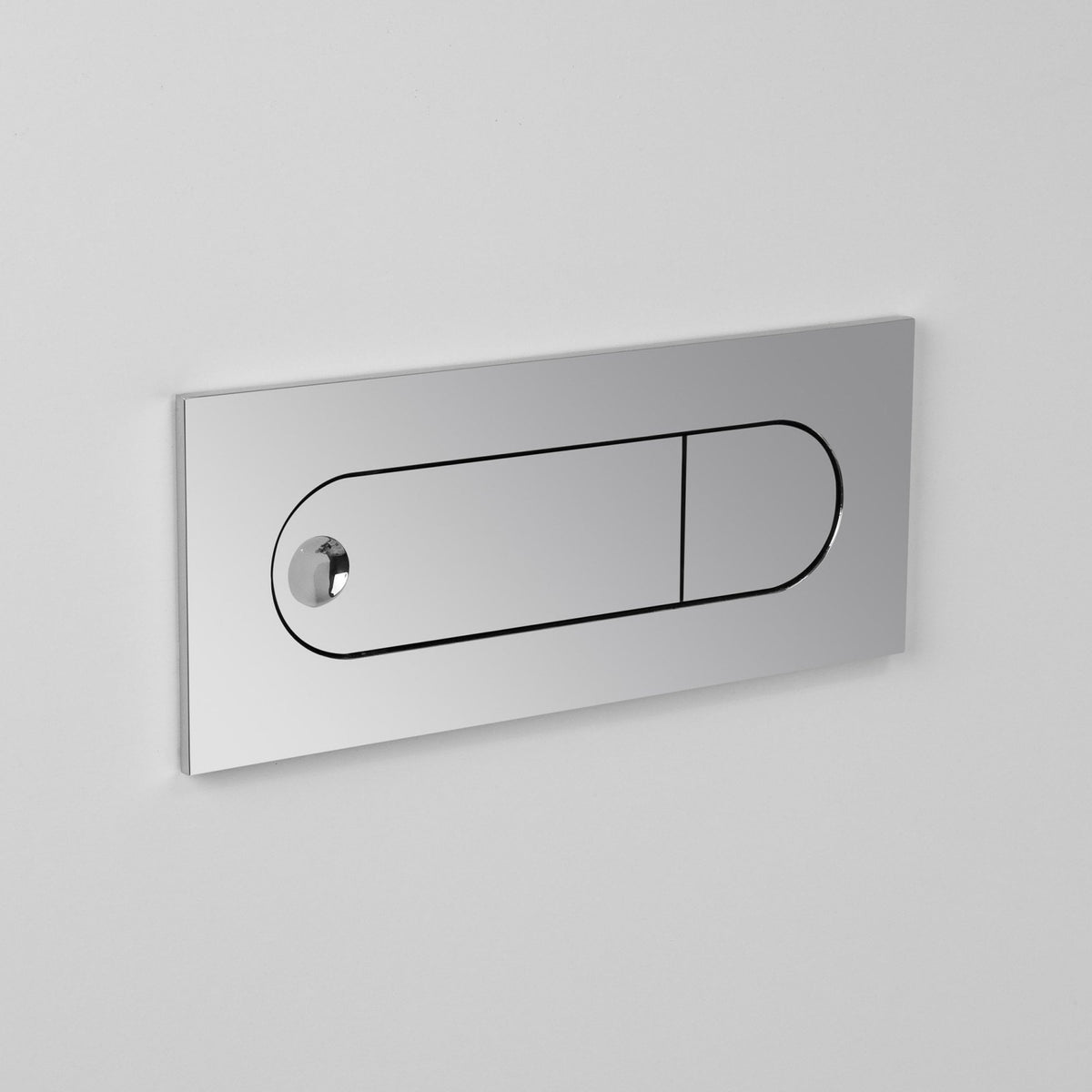 Chrome flush plate with two buttons, one small and one large, on a white wall