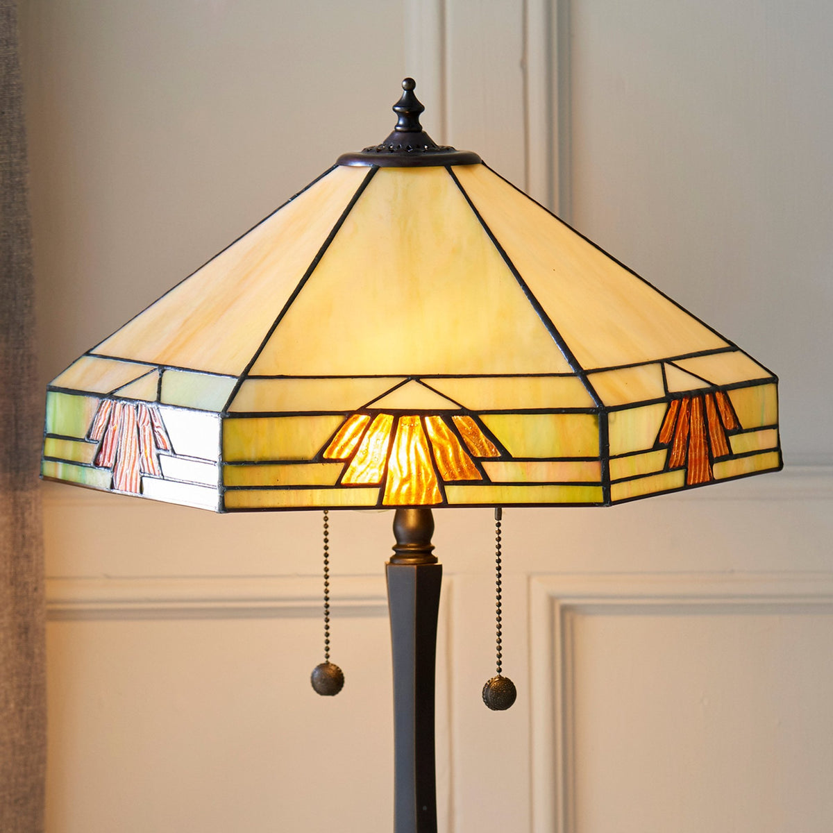 A Tiffany lamp with its distinctive stained-glass shade glowing warmly.